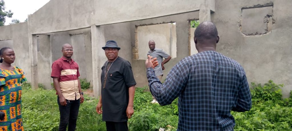 Circuit Superintendent Rev. Ebenezer Ballah and Bishop Quire infront of the Unroof clinic at Jaykay